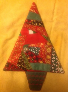 Use leftover wrapping paper or fabric to make a Christmas tree wall hanging